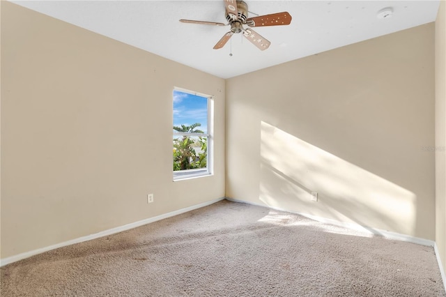 spare room with ceiling fan, carpet flooring, and baseboards