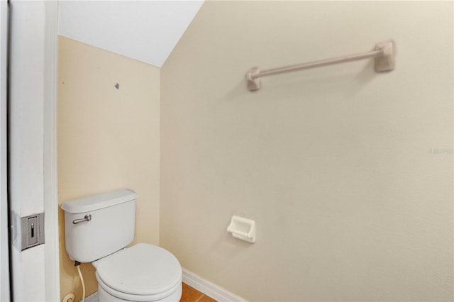 bathroom with toilet and baseboards