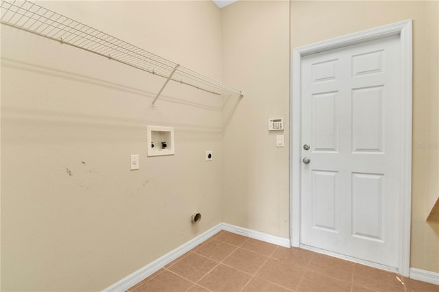 clothes washing area featuring light tile patterned floors, hookup for an electric dryer, laundry area, washer hookup, and baseboards