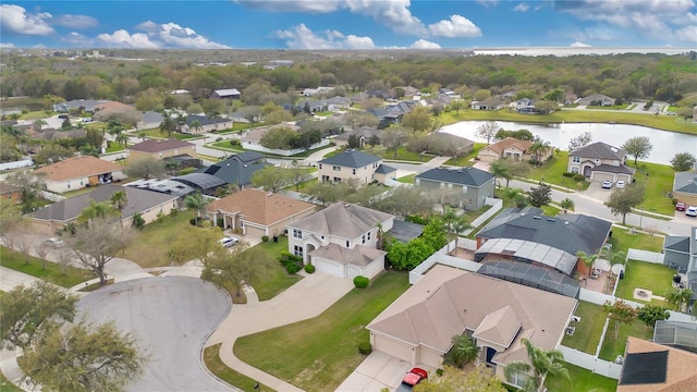 birds eye view of property with a water view and a residential view