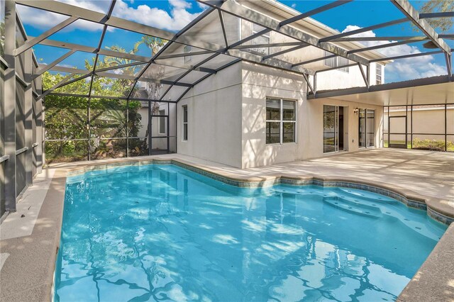 outdoor pool featuring a lanai and a patio area