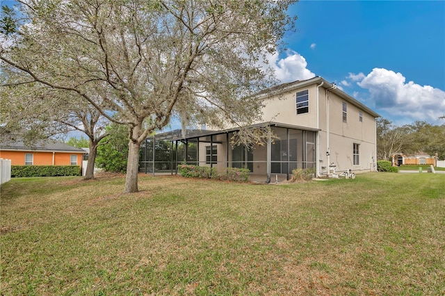 back of property featuring a lawn