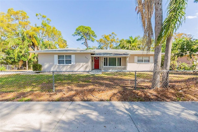 ranch-style house with a fenced front yard and stucco siding