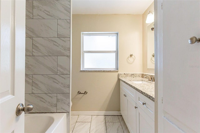 full bath with baseboards, marble finish floor, vanity, and  shower combination