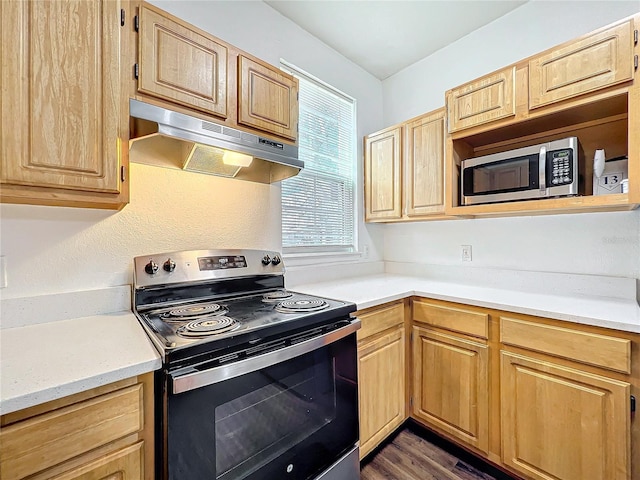 kitchen with under cabinet range hood, stainless steel microwave, electric stove, and light brown cabinetry