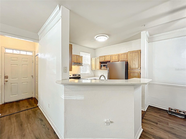 kitchen featuring under cabinet range hood, dark wood-type flooring, baseboards, light countertops, and appliances with stainless steel finishes