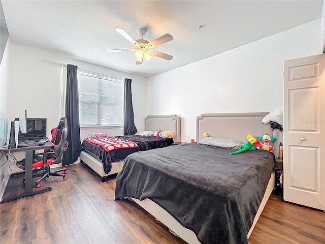 bedroom featuring a ceiling fan and wood finished floors