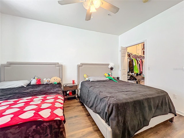 bedroom featuring a ceiling fan and wood finished floors