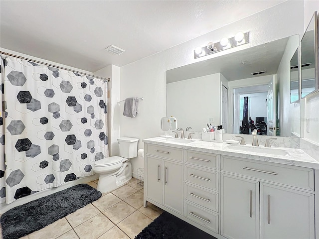 full bathroom featuring toilet, tile patterned flooring, visible vents, and a sink