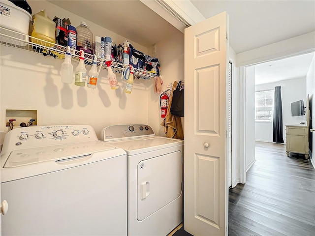 laundry room with laundry area, dark wood-type flooring, and washing machine and clothes dryer