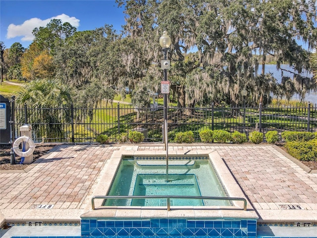 view of pool featuring fence