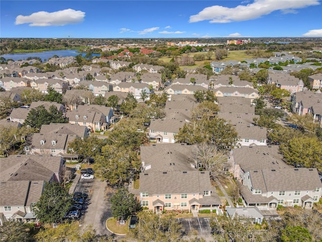 drone / aerial view with a residential view and a water view