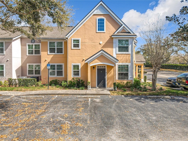 view of front of home featuring uncovered parking and stucco siding