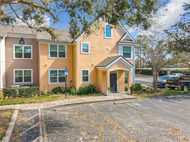 multi unit property with uncovered parking and stucco siding