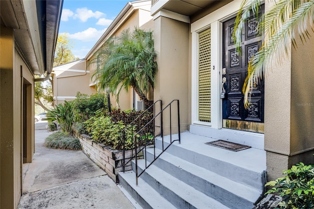 doorway to property with stucco siding