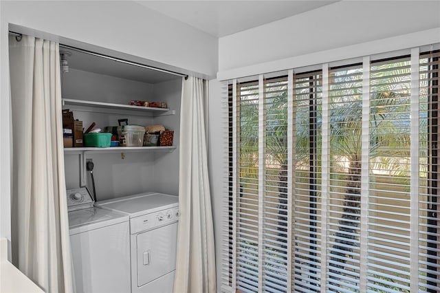 laundry area with a wealth of natural light, washing machine and dryer, and laundry area