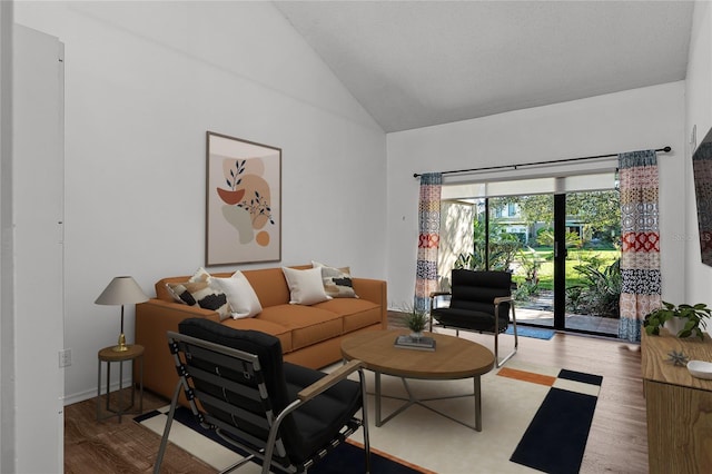 living room featuring high vaulted ceiling and wood finished floors