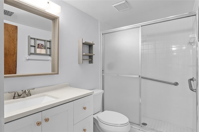 bathroom featuring toilet, a stall shower, visible vents, and vanity