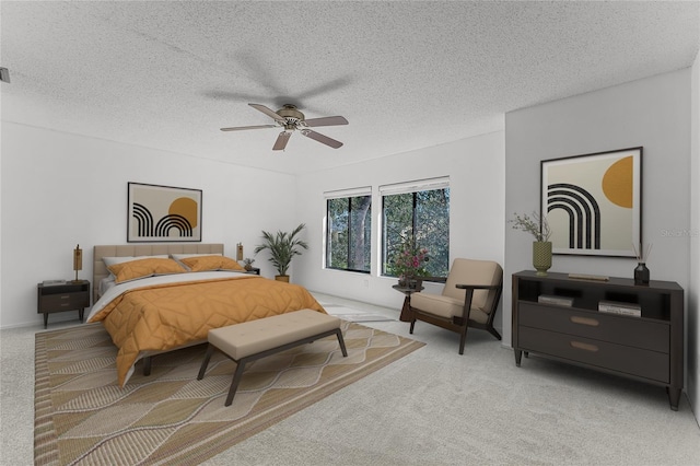 carpeted bedroom featuring a ceiling fan and a textured ceiling