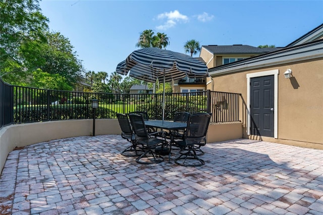 view of patio featuring fence and outdoor dining area