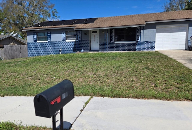 ranch-style house featuring solar panels, a porch, fence, a garage, and a front lawn