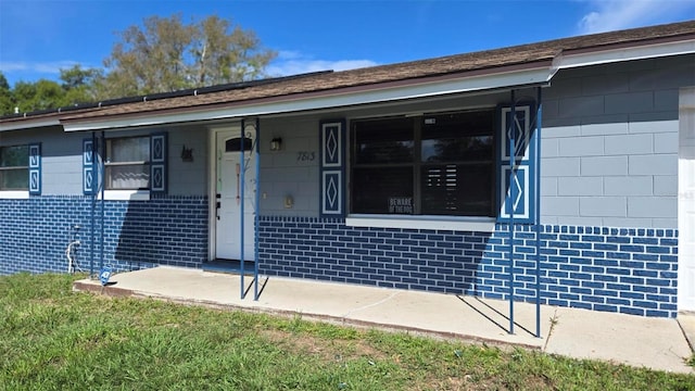 view of front of house featuring covered porch and brick siding