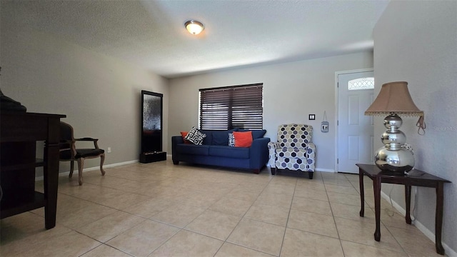 living room with light tile patterned floors, a wealth of natural light, and baseboards