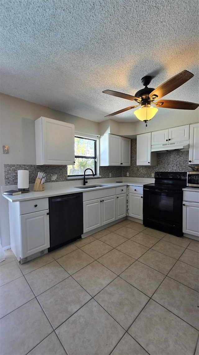 kitchen featuring black appliances, a sink, white cabinetry, and under cabinet range hood