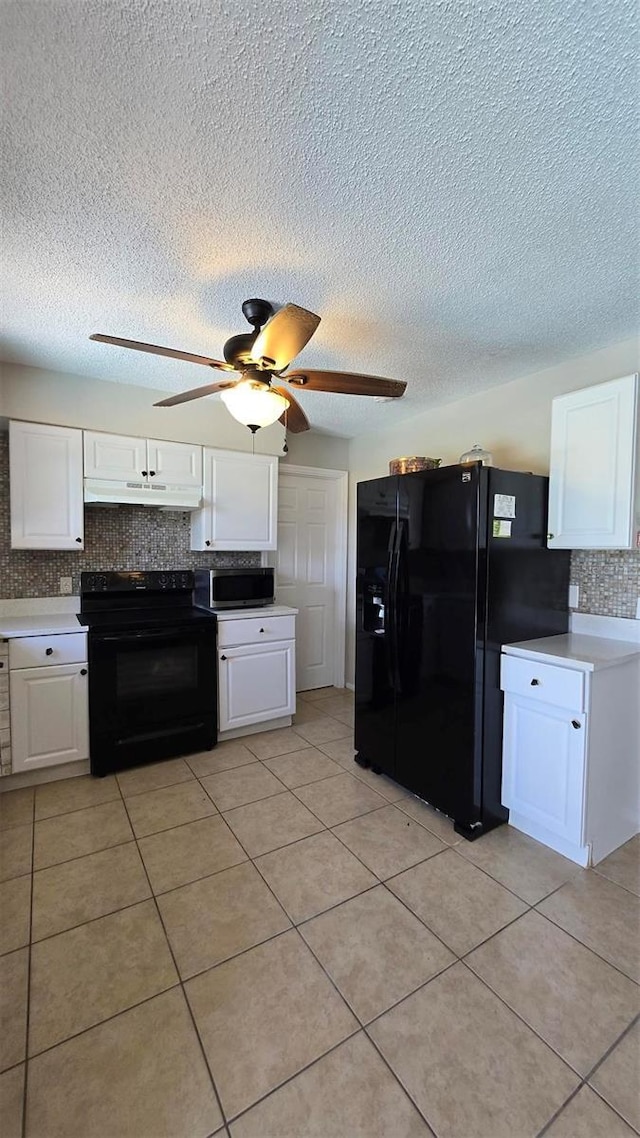 kitchen featuring under cabinet range hood, light countertops, black appliances, white cabinetry, and backsplash