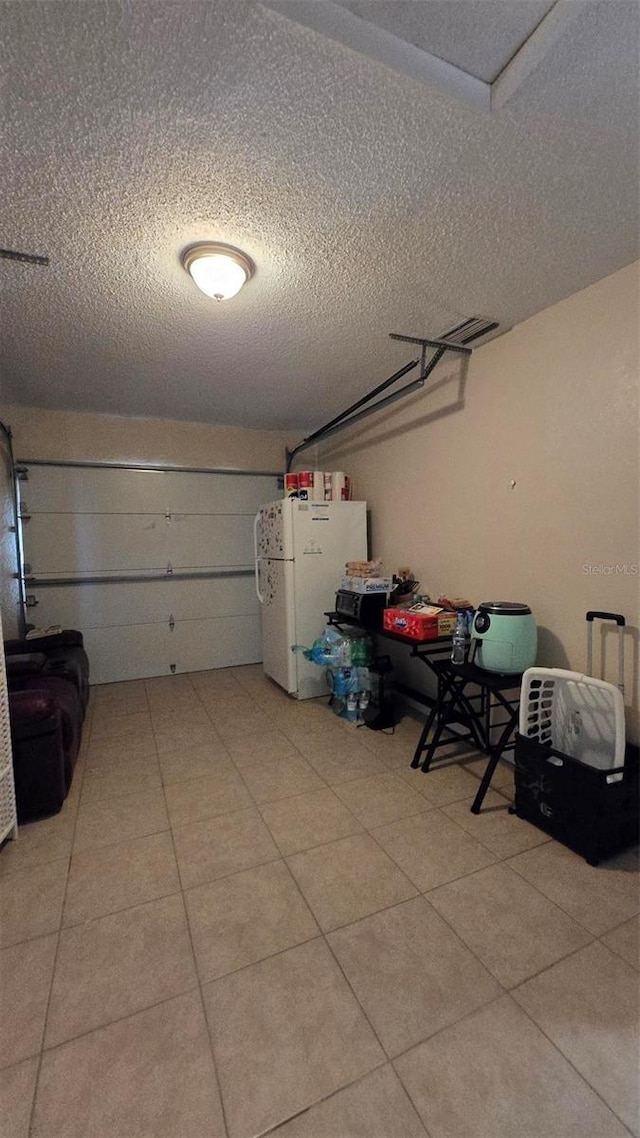 garage with freestanding refrigerator