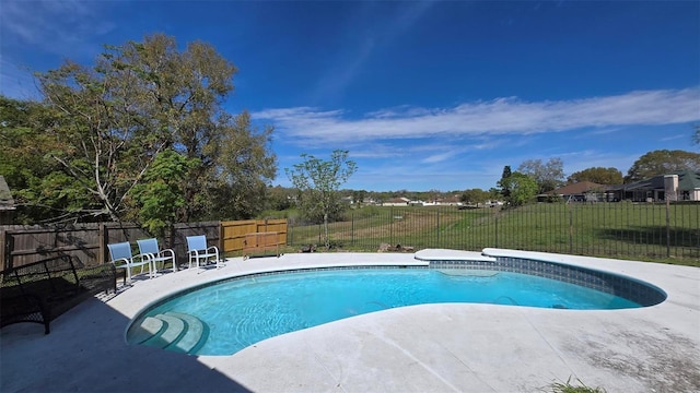 view of swimming pool featuring a yard, a fenced backyard, a fenced in pool, and a patio