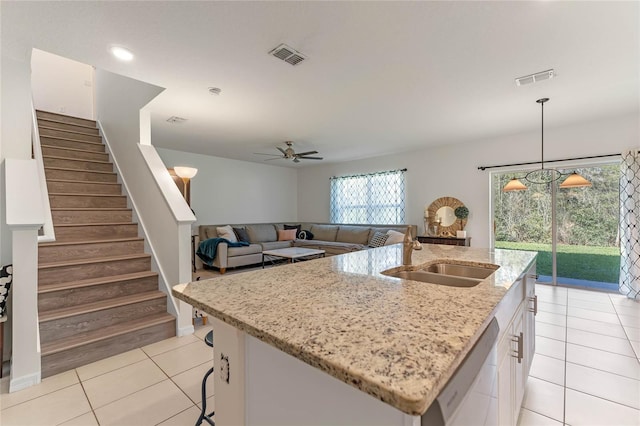 kitchen featuring light tile patterned floors, visible vents, dishwasher, white cabinetry, and a sink