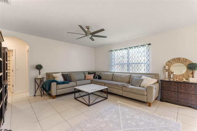 living room featuring arched walkways, ceiling fan, light tile patterned flooring, and visible vents