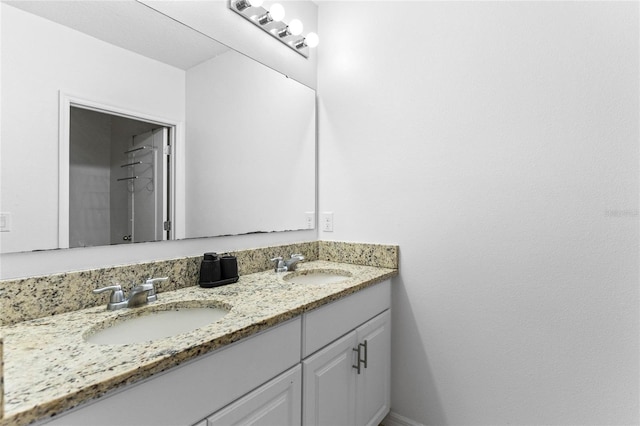 bathroom with a sink and double vanity