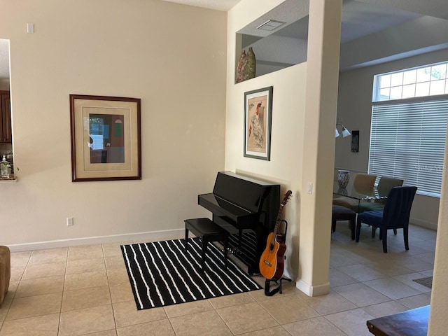 living area featuring visible vents, baseboards, and tile patterned floors