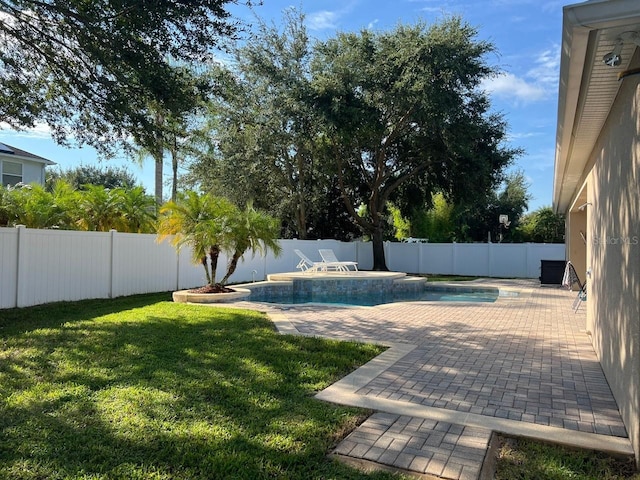 view of swimming pool featuring a fenced backyard, a fenced in pool, a lawn, and a patio