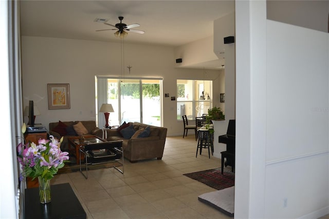 living area featuring a ceiling fan, visible vents, and light tile patterned floors