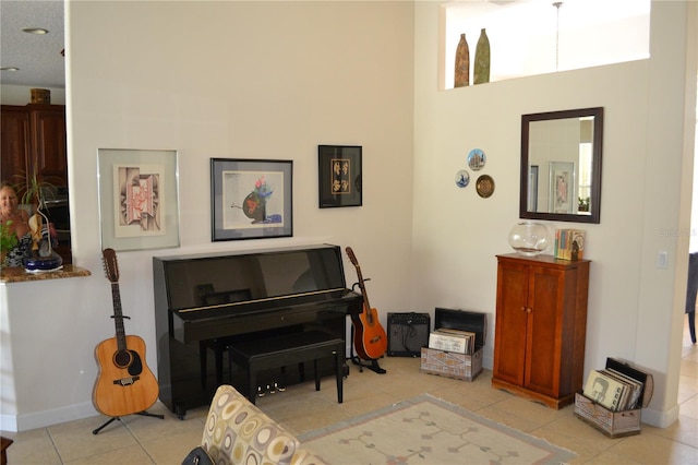 living area featuring baseboards and light tile patterned flooring