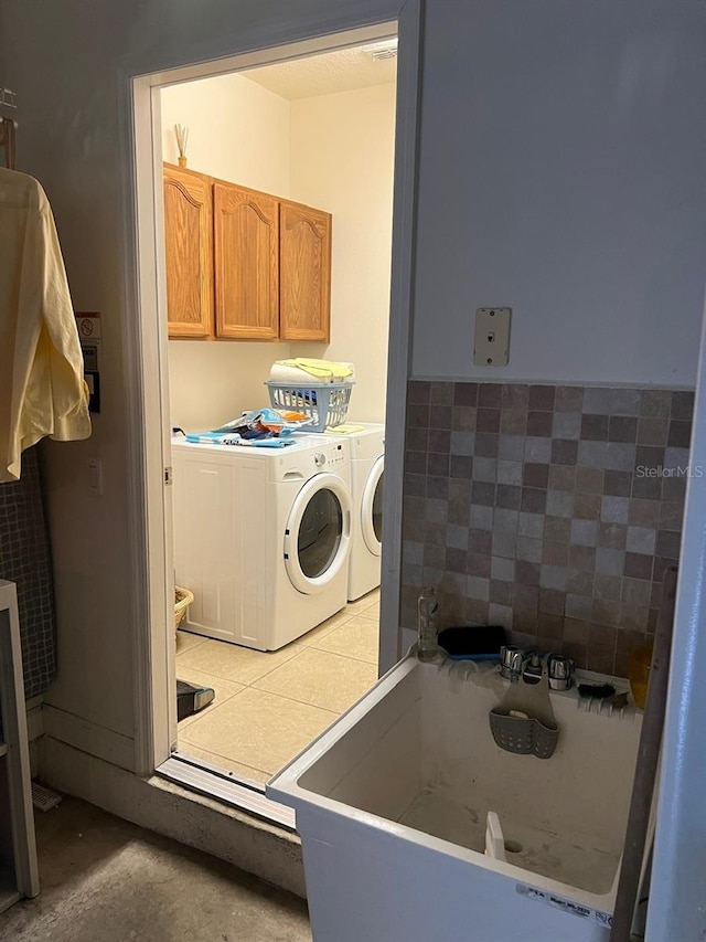 laundry room with laundry area, washer and clothes dryer, and a sink