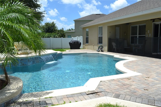 view of swimming pool with a patio area, fence, and a fenced in pool