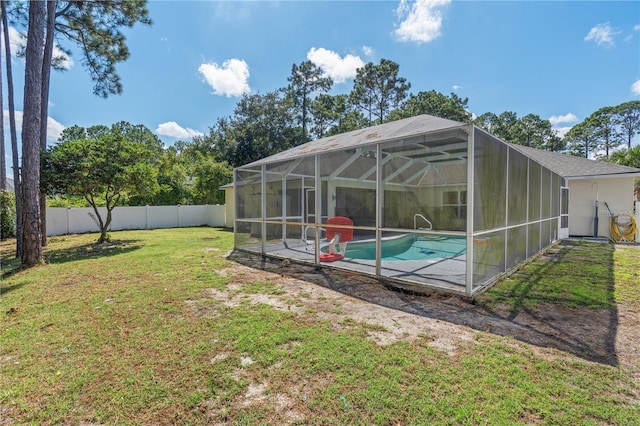 view of yard featuring a fenced in pool, a lanai, a fenced backyard, and a patio