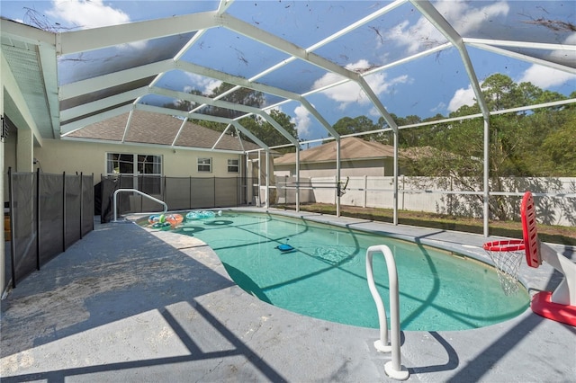 view of pool with a patio area, a fenced backyard, and a lanai