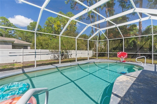 view of pool with a lanai, fence, a fenced in pool, and a patio