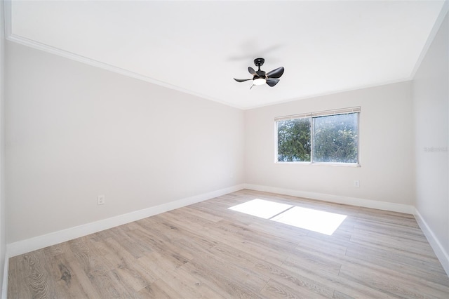 empty room featuring baseboards, ceiling fan, ornamental molding, and light wood-style floors