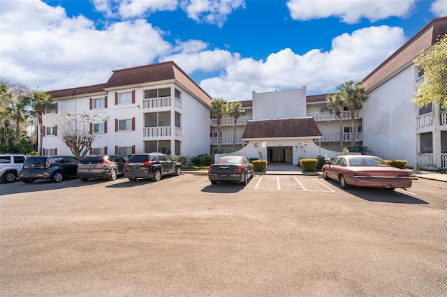 view of building exterior featuring uncovered parking