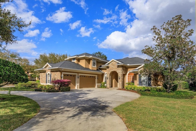 view of front of property with a garage, driveway, a front lawn, and stucco siding