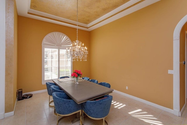 1704 Kersley Cir, Lake Mary, FL 32746 - dining area with arched walkways, baseboards, ornamental molding, tile patterned floors, and a raised ceiling
