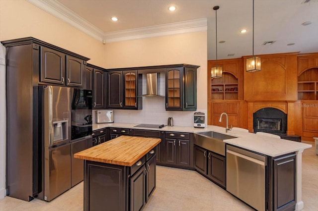 1704 Kersley Cir, Lake Mary, FL 32746 - kitchen with stainless steel appliances, a sink, wall chimney range hood, butcher block countertops, and a peninsula