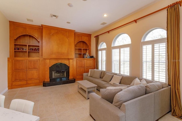 1704 Kersley Cir, Lake Mary, FL 32746 - living area with light tile patterned floors, built in shelves, a fireplace, and visible vents