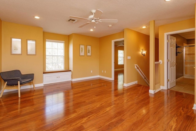1704 Kersley Cir, Lake Mary, FL 32746 - unfurnished living room with baseboards, ceiling fan, wood finished floors, a textured ceiling, and recessed lighting